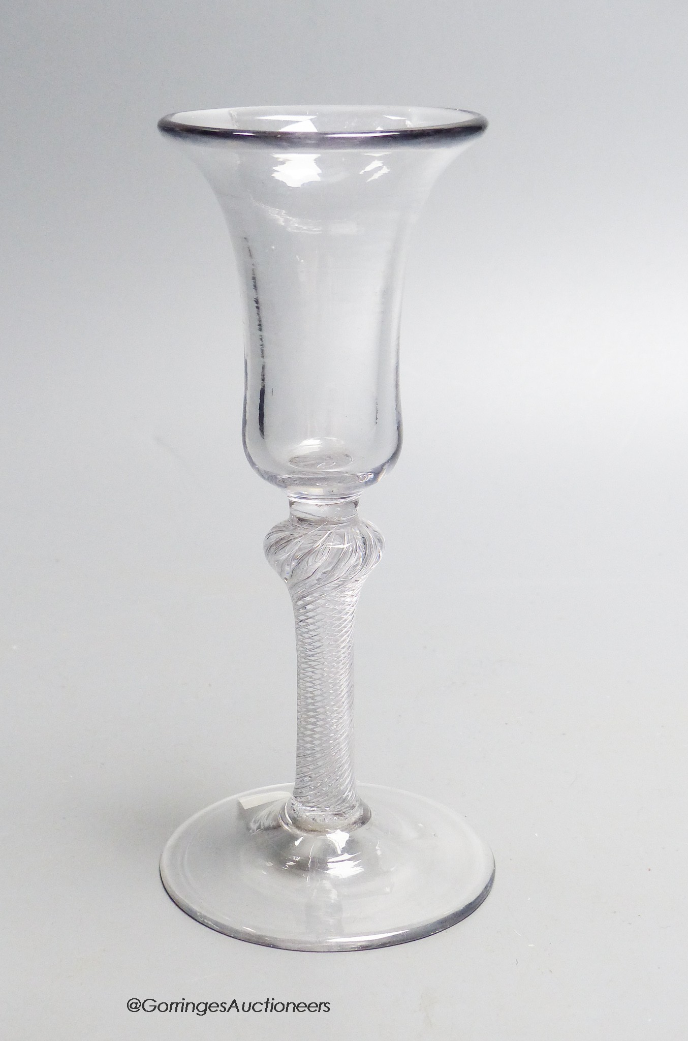 A Georgian air twist stem wine glass c.1750, a bell shaped bowl. 17cm